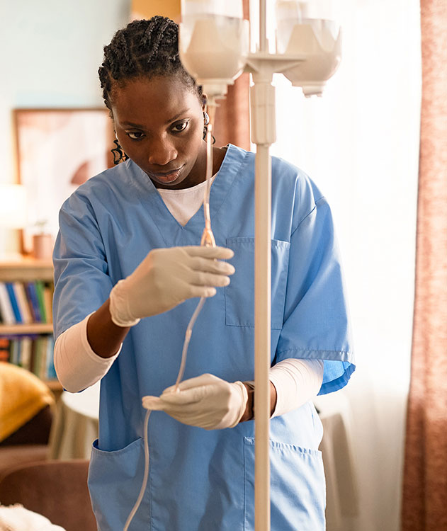 A nurse adjusting an IV drip.