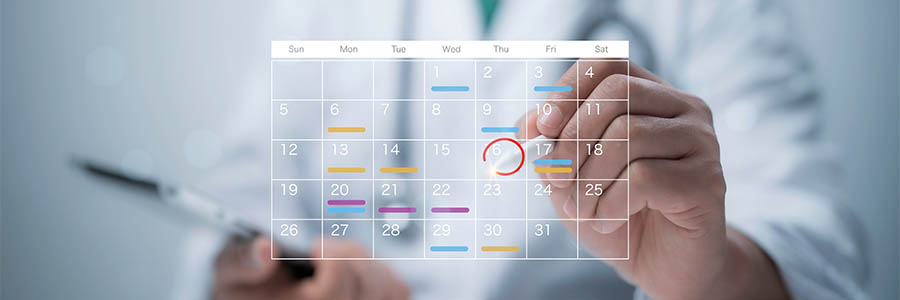 Doctor writing on a calendar