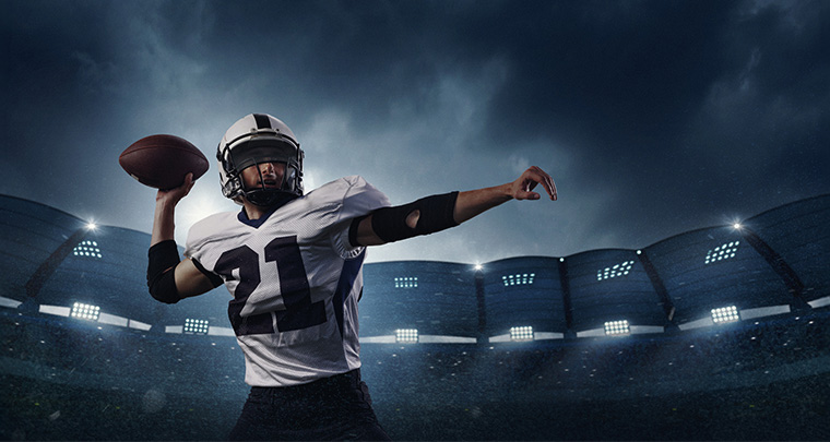 A football player throwing a football
