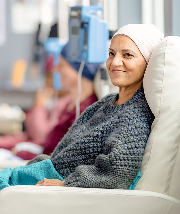 A smiling woman receiving medical treatment in a clinic.