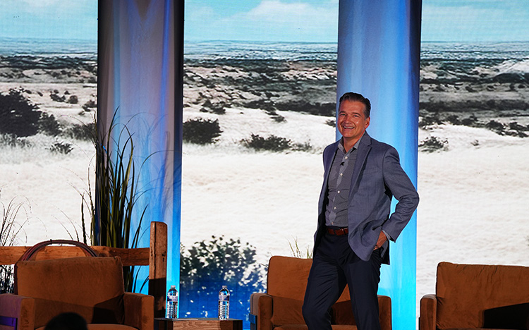 A speaker is giving a speech on stage